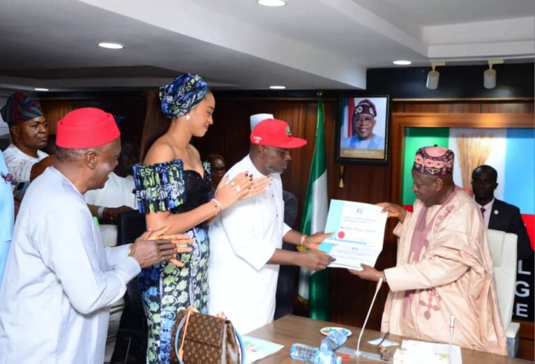 Nicholas-Ukachukwu-receiving-the-certificate-of-return-from-Ganduje